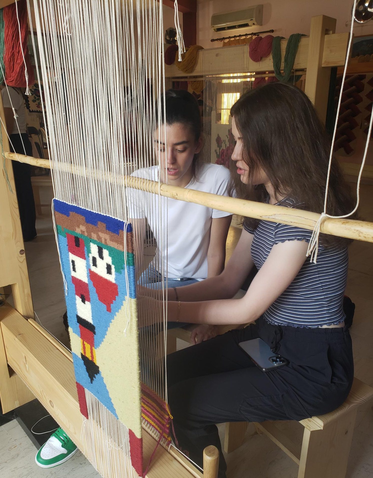 Image of students learning how to weave kilims