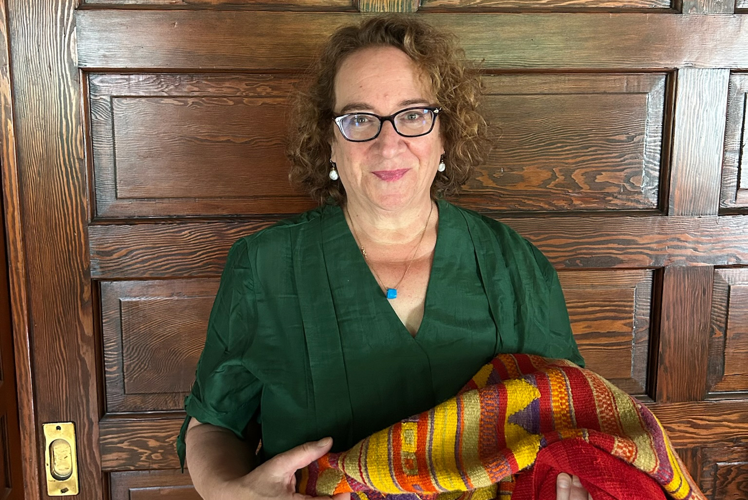 Image of Professor Sharon Gerstel with weaving by Mayme